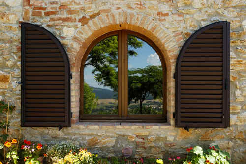 la armoniosa finestra ad arco della cucina degli ulivi dove si riflette il paesaggio